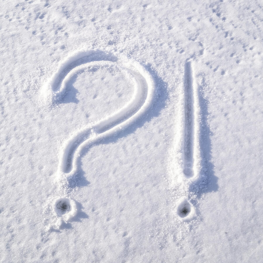 Question mark and exclamation point drawn in fresh snow
