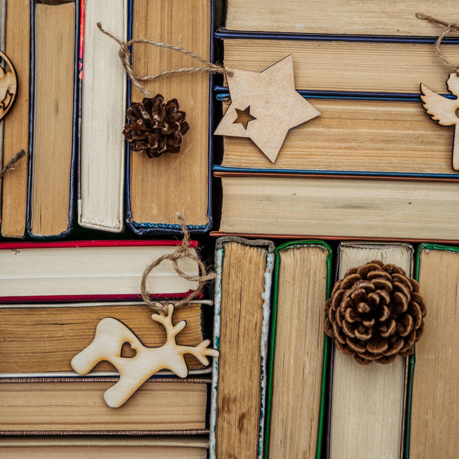 Traditional Christmas decorations adorning a stack of old books