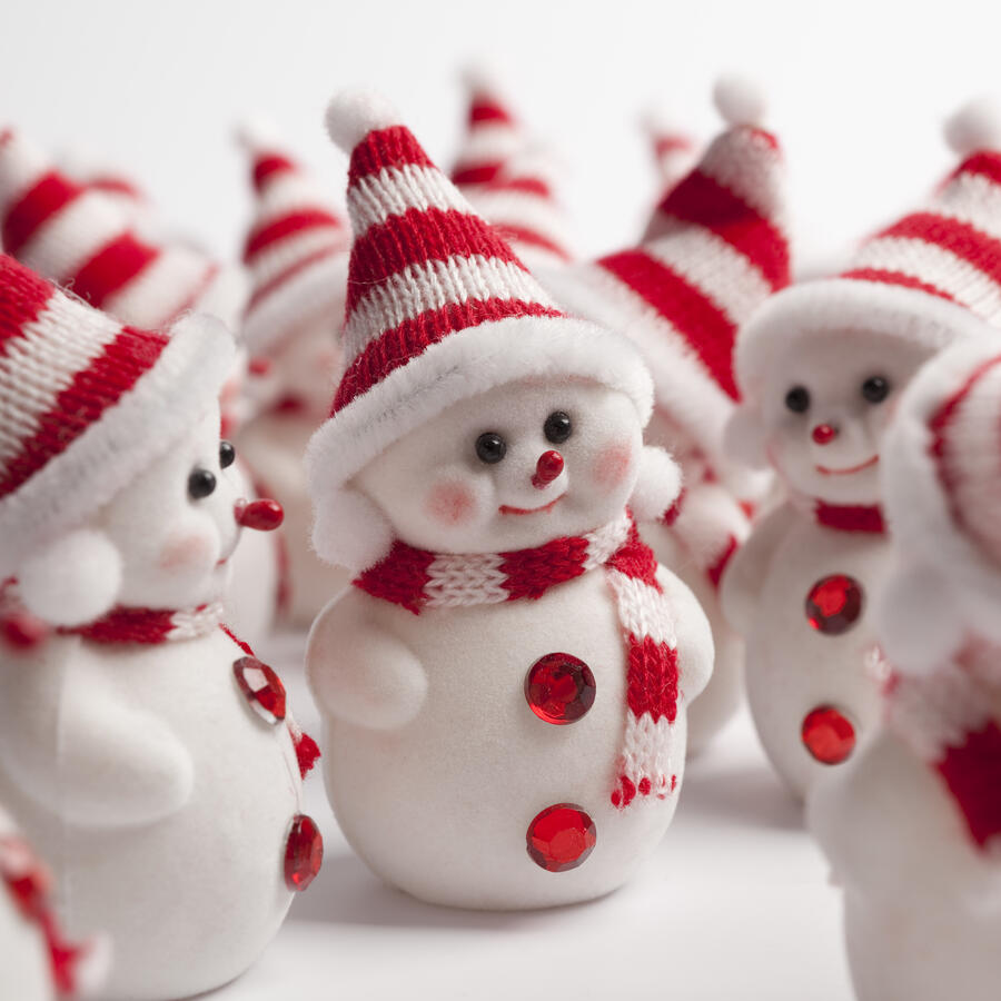 Picture of cute little snow-people wearing red and white winter accessories