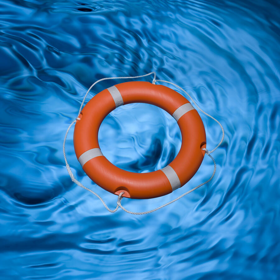 Beautiful blue rippled water with an orange life ring floating on top